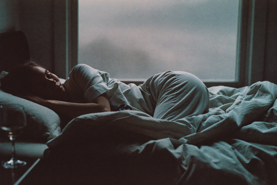 A woman awake at four in the morning in cold pre-dawn light